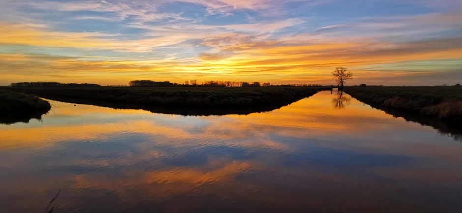 Kleurrijke zonsondergang over de polder