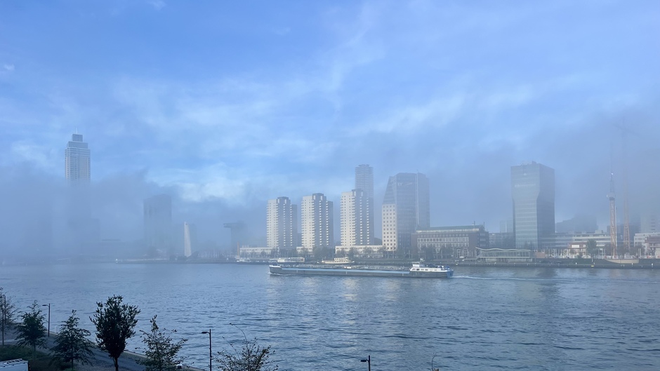 Mist trekt over het water en de stad 