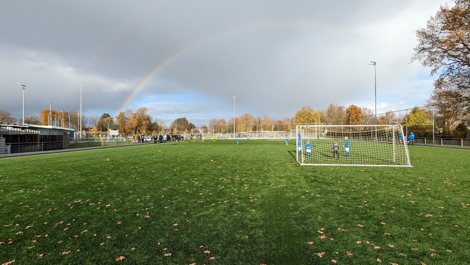 Regenboog langs het voetbalveld 